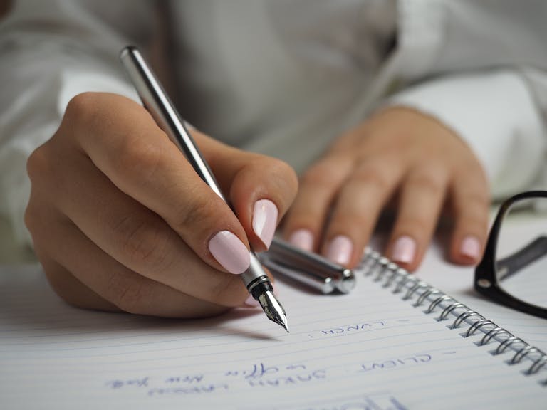 Calm professional taking notes during a review meeting showing composure techniques