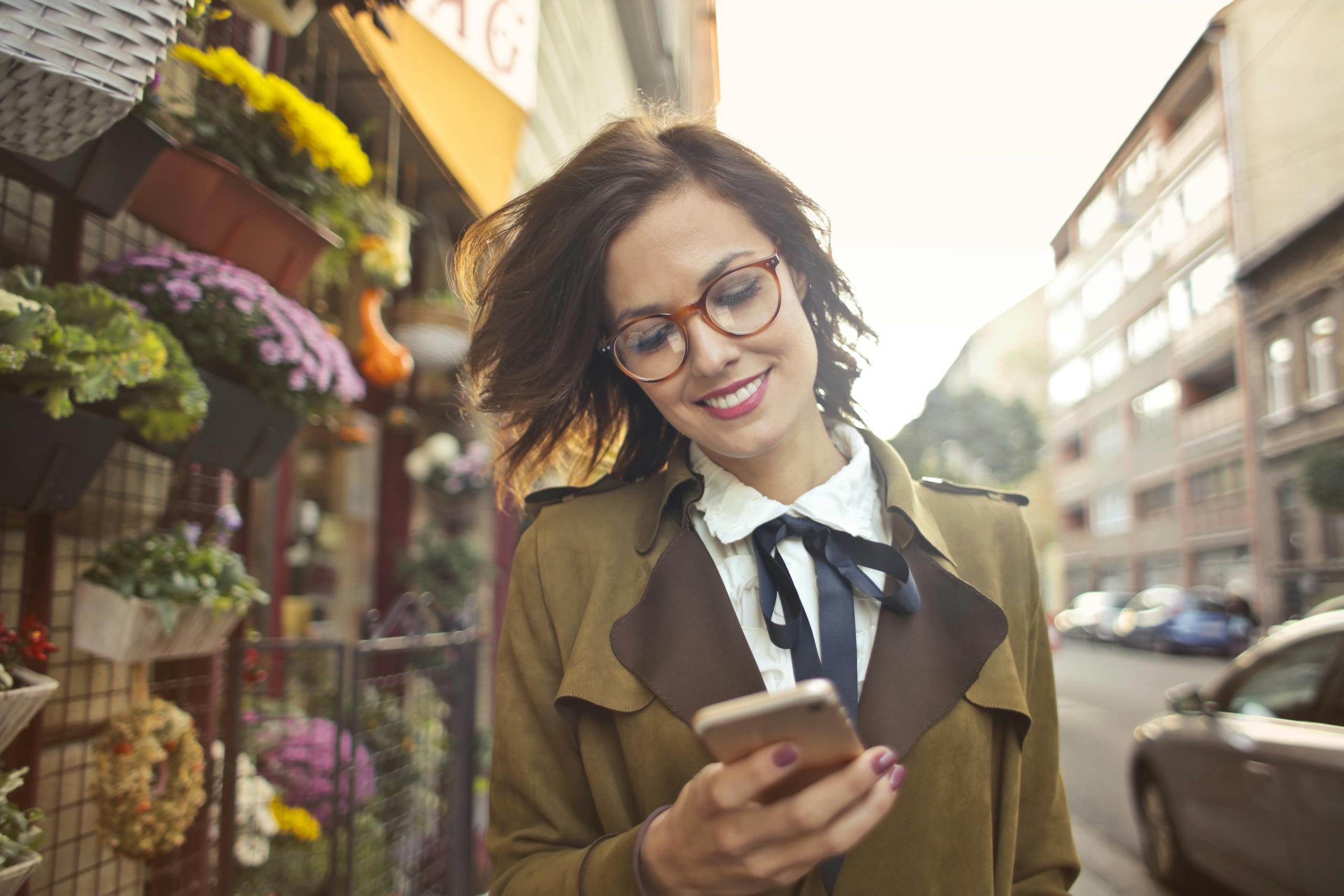 Woman using phone outdoors balancing technology and fresh air