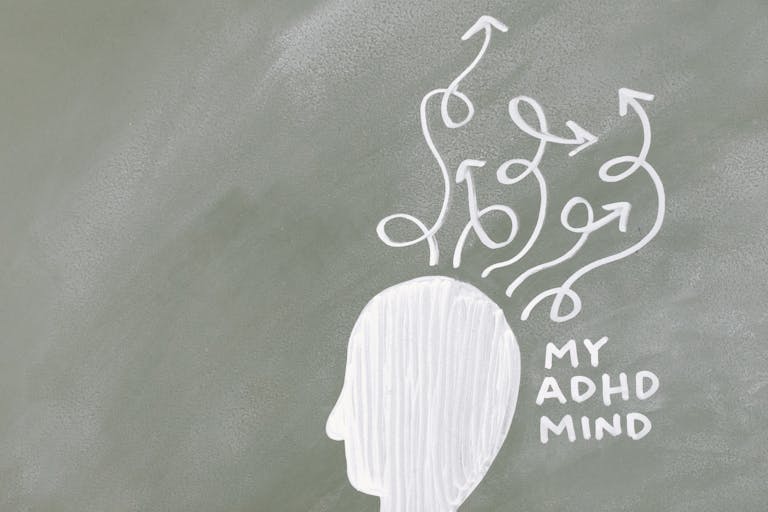 Creative depiction of the ADHD mind with chalk arrows on a green board.