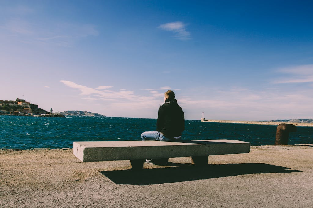 Person practicing deep breathing in a public space to manage anxiety