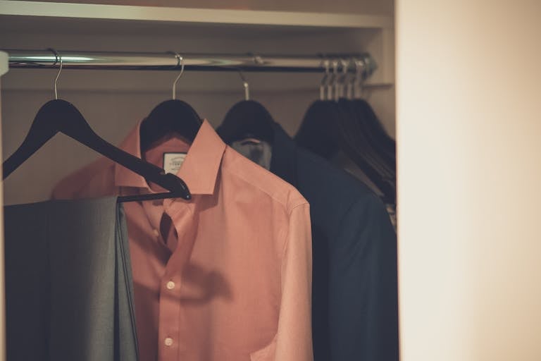 Capsule wardrobe organized in minimal closet space demonstrating sustainable fashion choices