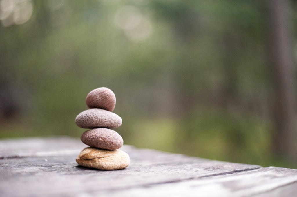 Balanced stones stacked carefully, representing the delicate balance INFJ therapists must maintain between helping others and self-care