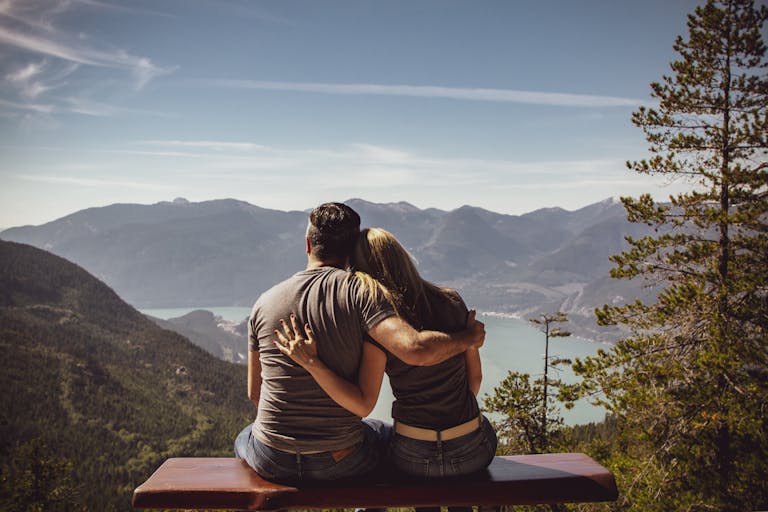 Happy couple sitting together peacefully, representing the meaningful connection possible when introverts with social anxiety find understanding partners