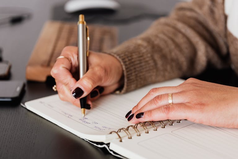 Woman writing on a weekly meal plan checklist at home