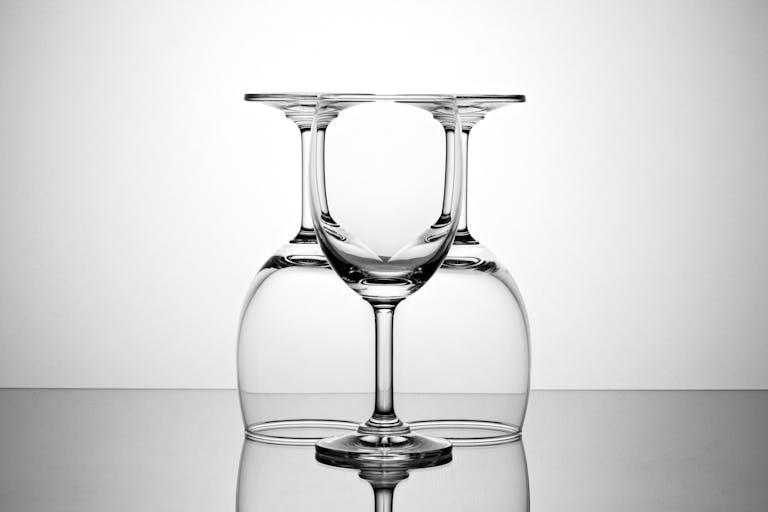 Elegant display of inverted and upright wine glasses showcasing symmetry and reflection.