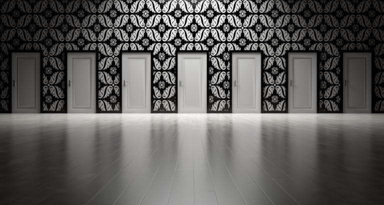 Five closed doors in a black and white ornate hallway symbolizing opportunities and decisions.