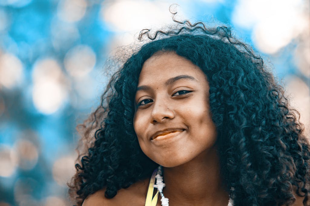 Portrait of a smiling young woman with curly hair outdoors in Bocas del Toro, Panama.