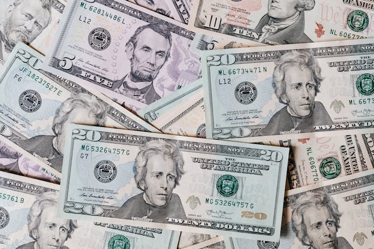 Top view of different types and colors American dollars placed together on each other