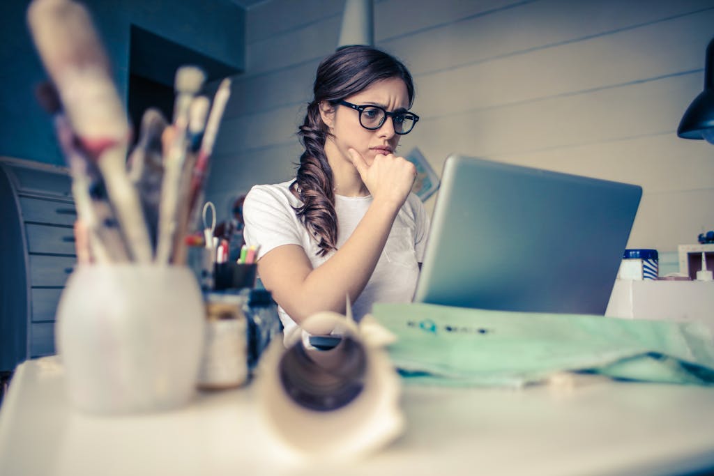Professional looking thoughtful while working alone at desk with strategic planning materials
