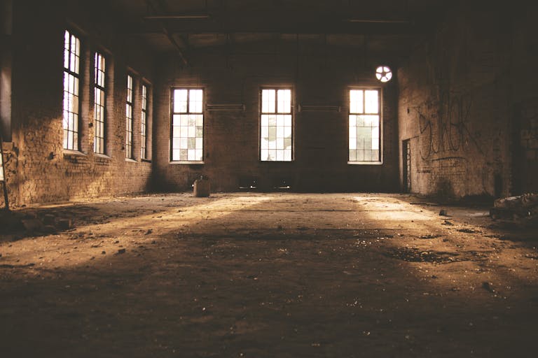 Dilapidated factory interior with sunlight streaming through windows in Rheinsberg, Germany.