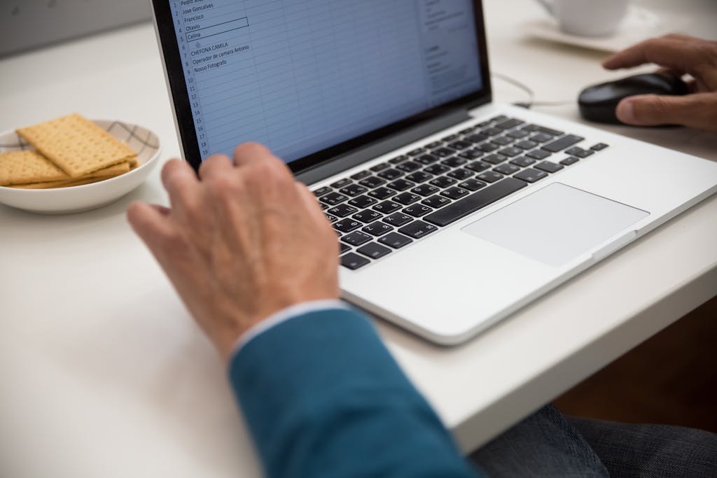 Mature professional studying code on multiple monitors in quiet workspace, demonstrating focused deep learning approach typical of introverted learners