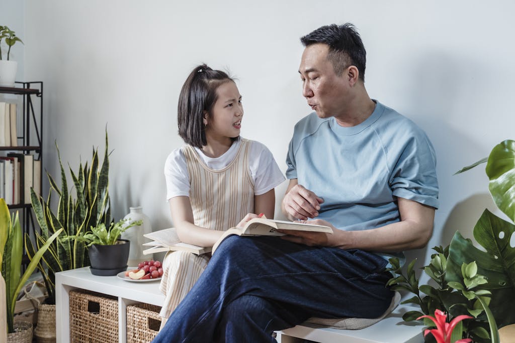 INTP parent sitting thoughtfully while ESFJ child expresses emotions, showing the contrast between internal processing and external expression in family relationships