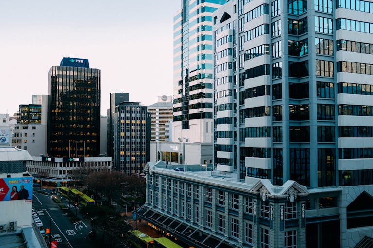 A bustling urban skyline with modern skyscrapers and city streets during the day.