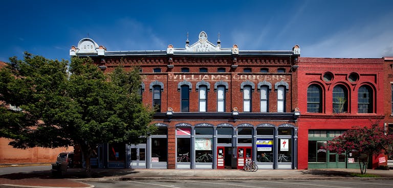 A historic building facade in Oneonta, featuring stores and vintage architectural details.