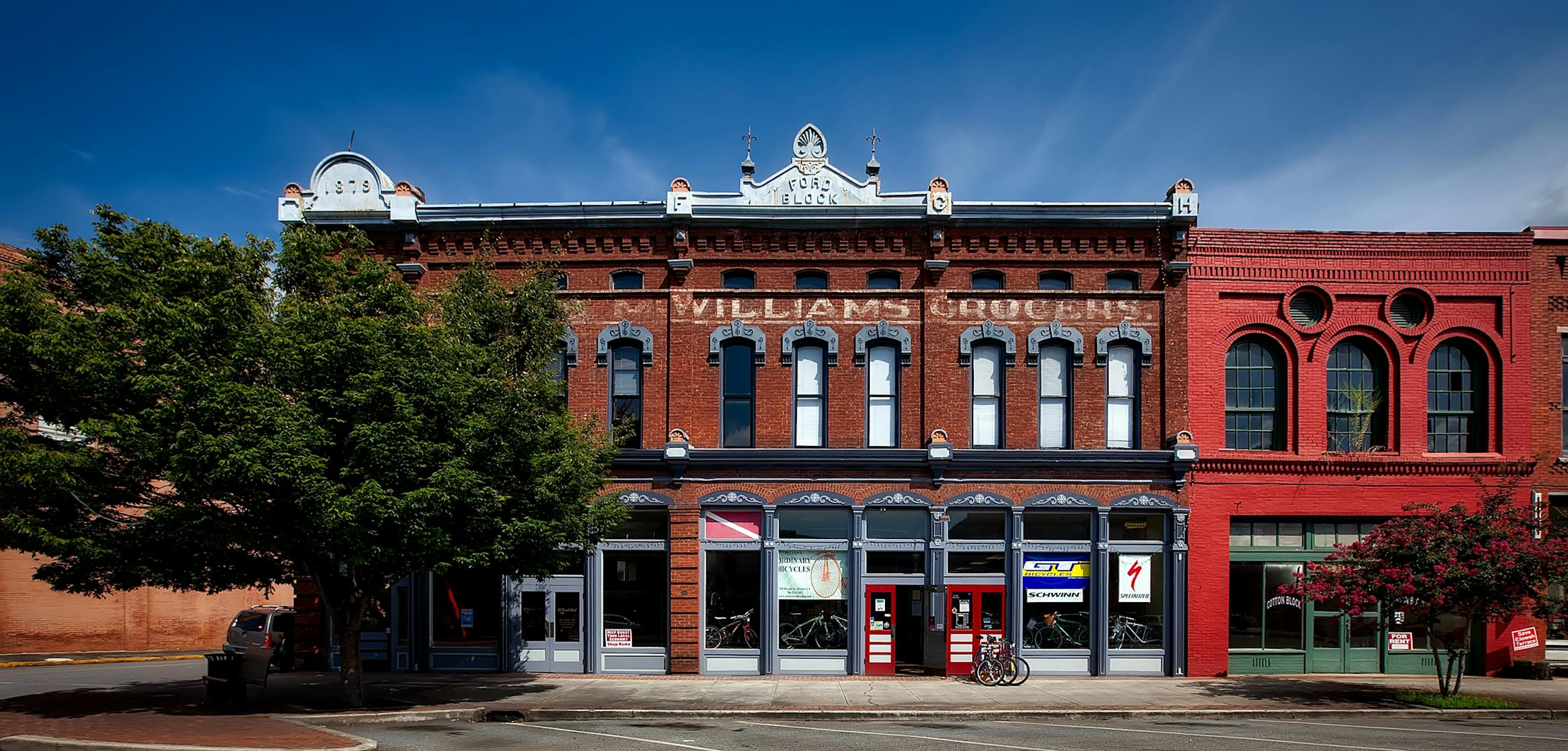 A historic building facade in Oneonta, featuring stores and vintage architectural details.