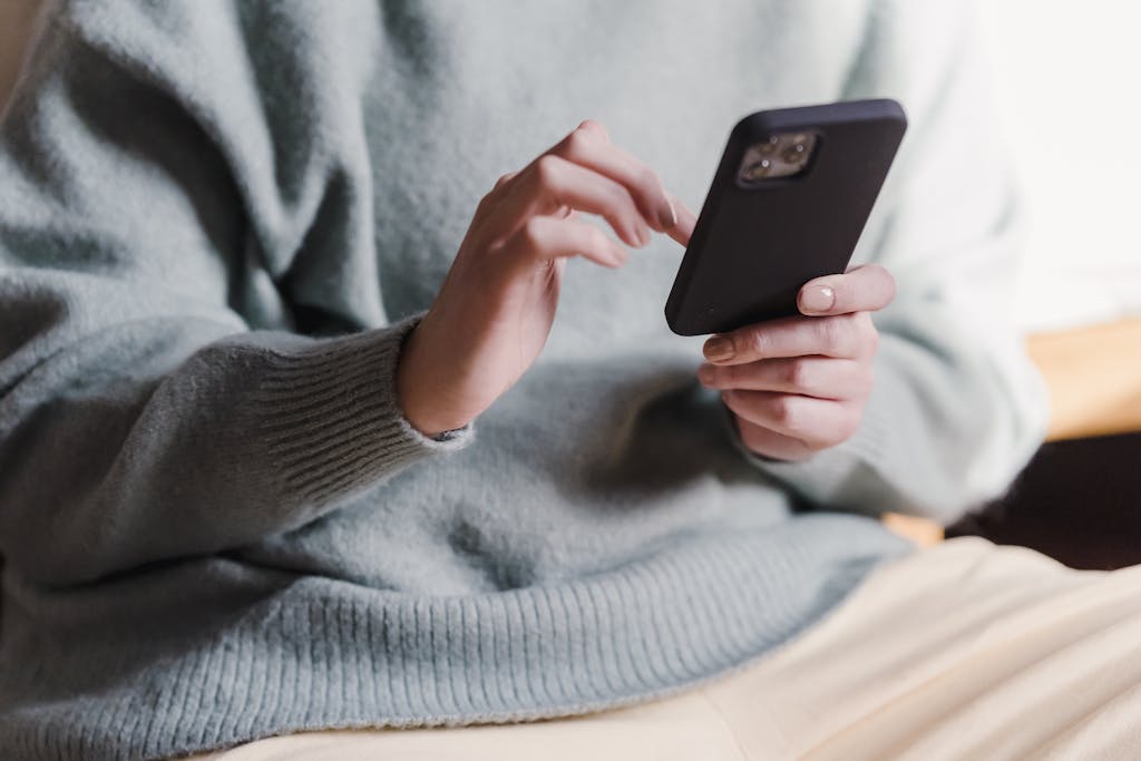 Cozy reading nook with smartphone showing wellness app interface