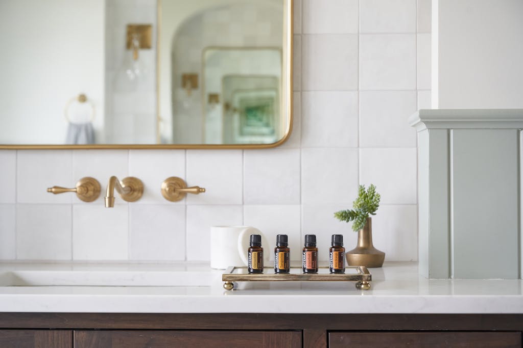 Minimalist bathroom counter with only essential products arranged neatly showing bathroom routine minimalism