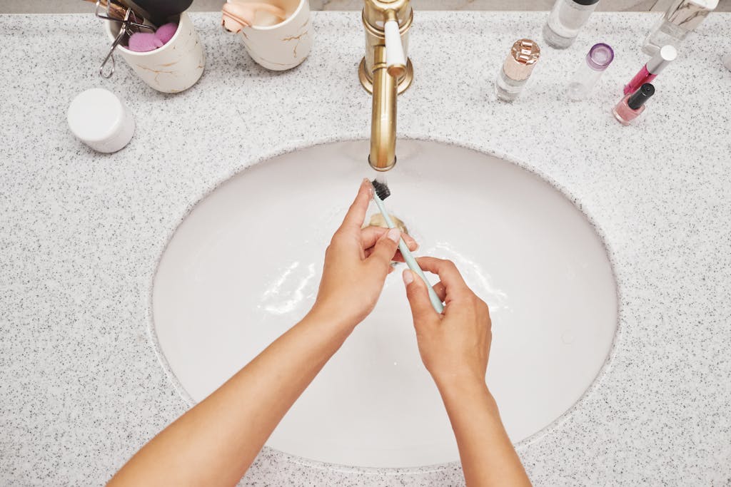 Person practicing mindful morning self care routine in simple bathroom environment
