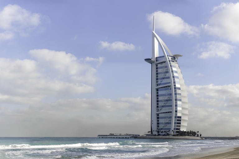 Stunning view of Burj Al Arab with a serene beach setting in Dubai, UAE.