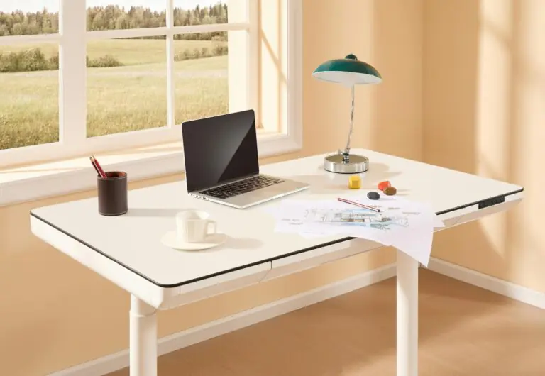 Bright modern home office with adjustable desk laptop and sketches
