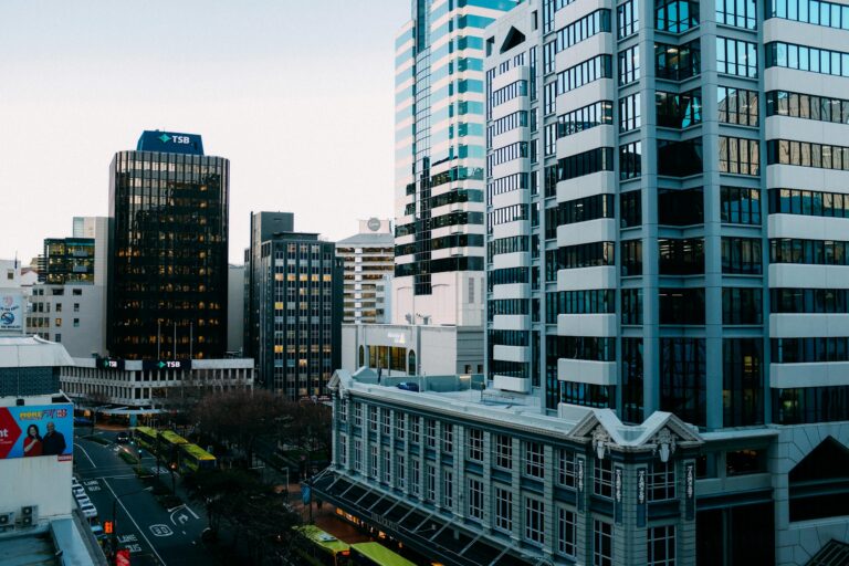 Bustling urban skyline with modern skyscrapers and city streets during the day.