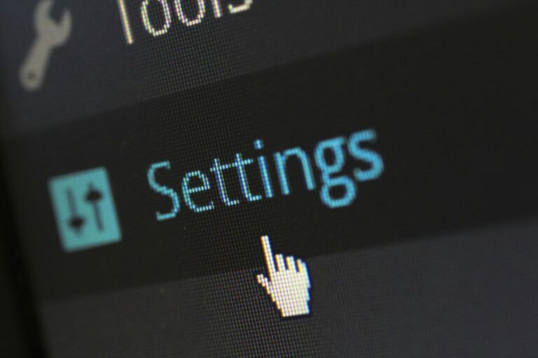 Close-up of computer screen settings button with cursor hovering over it.