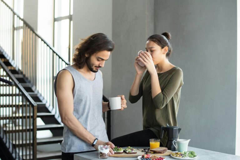 Couple enjoying cozy breakfast with coffee and juice in modern home kitchen
