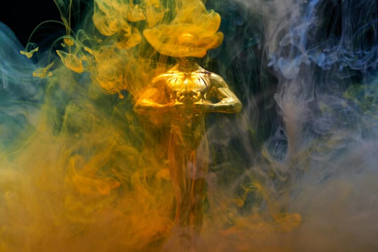 Golden statuette enveloped in vibrant yellow and blue smoke symbolizing achievement