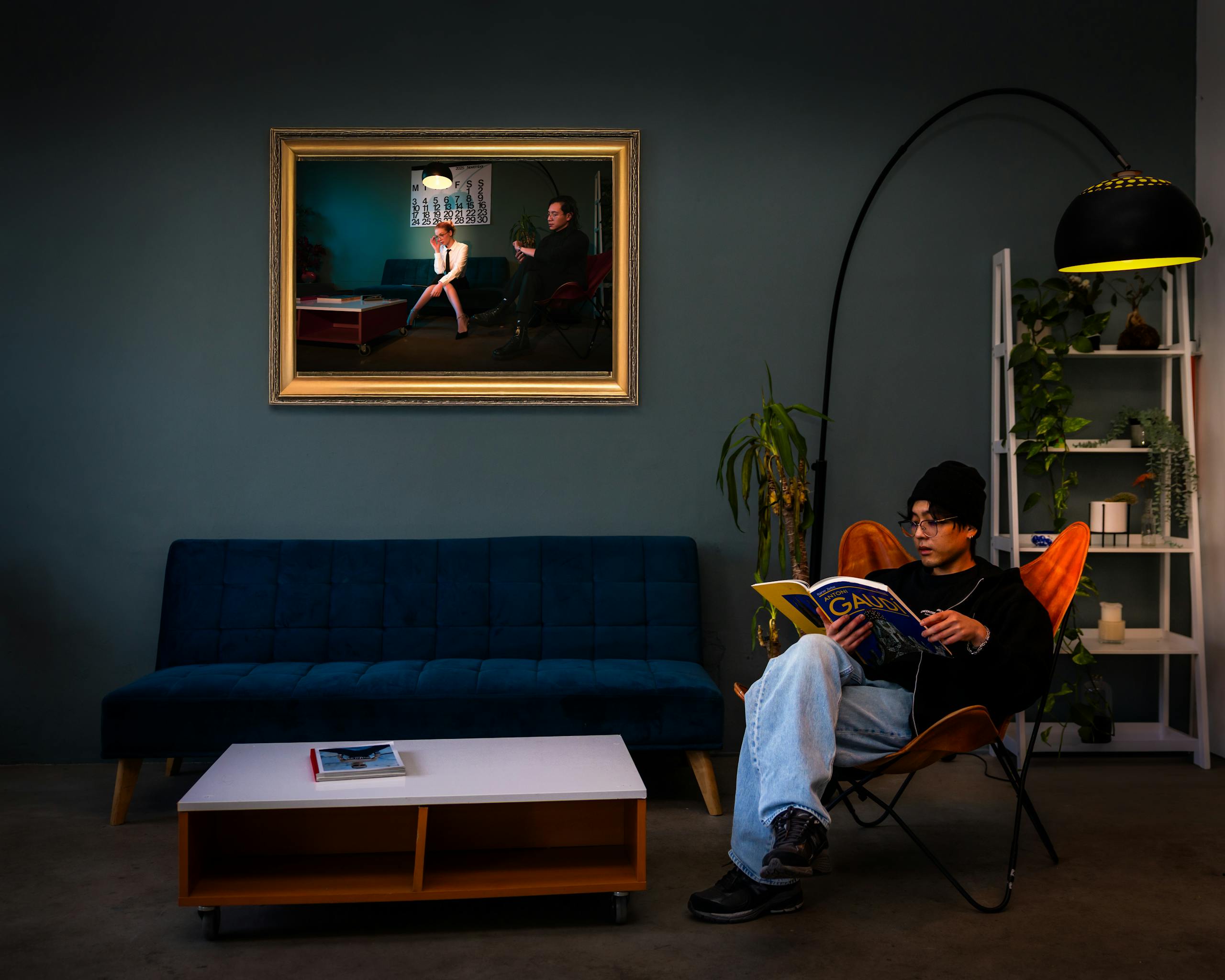 Person reading in stylish living room with modern decor and wall art