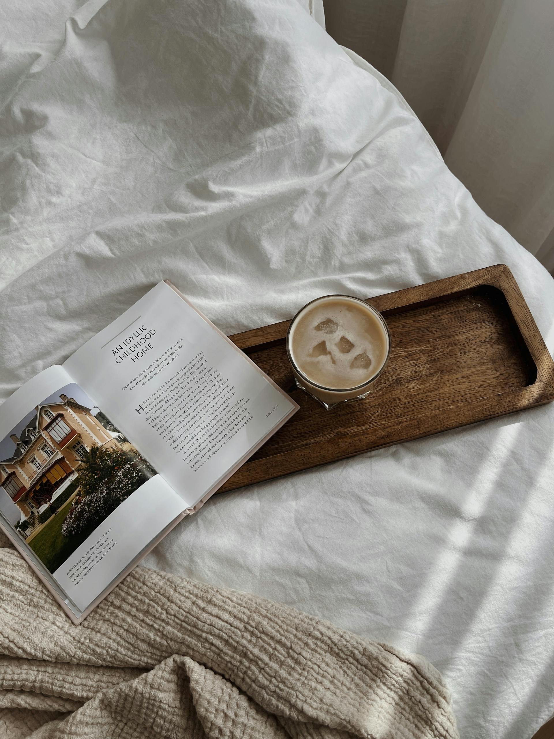 Serene morning bedside scene with coffee and magazine for relaxation.