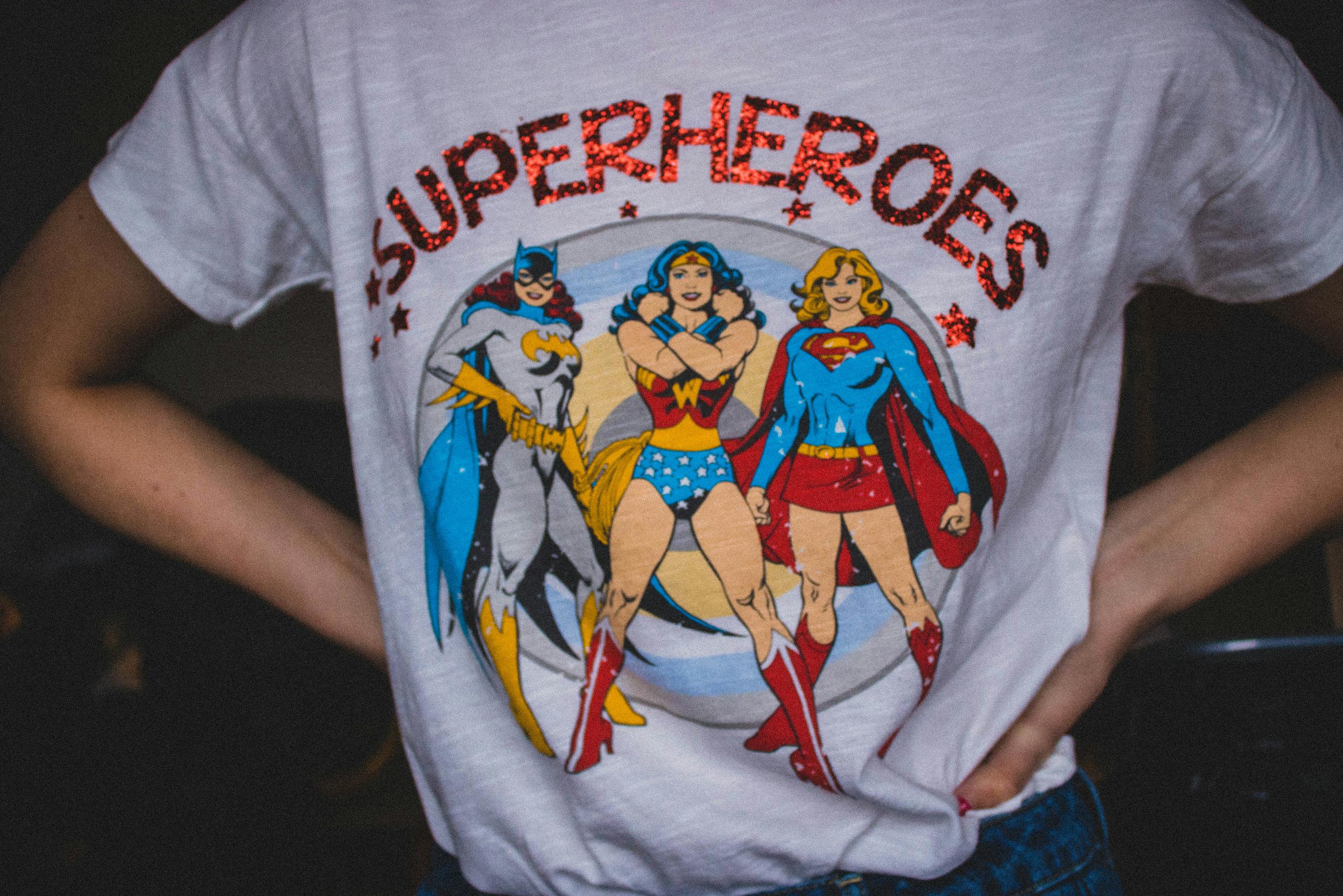 Vibrant superhero-themed t-shirt with bold female comic book characters design.