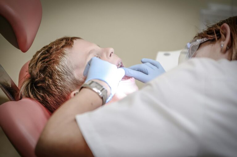 Young boy receiving professional dental examination from dentist in modern clinic setting