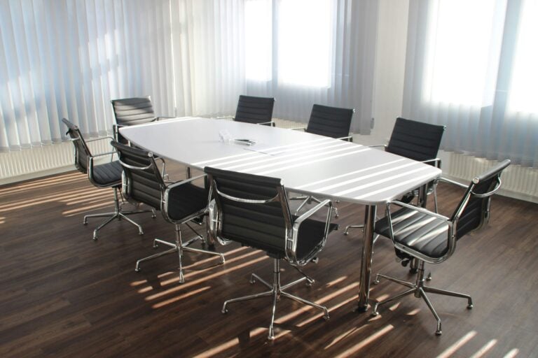 Empty conference room with organized seating and bright natural light streaming through windows