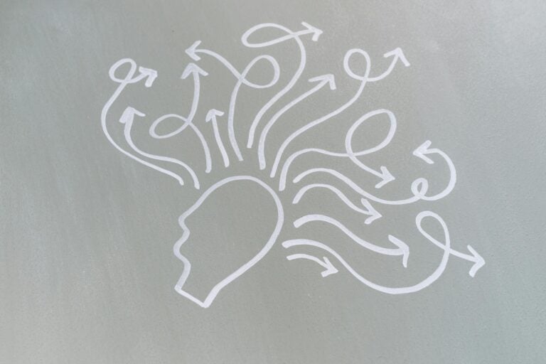 Chalk drawing of head with swirling arrows represents mental activity and thought process
