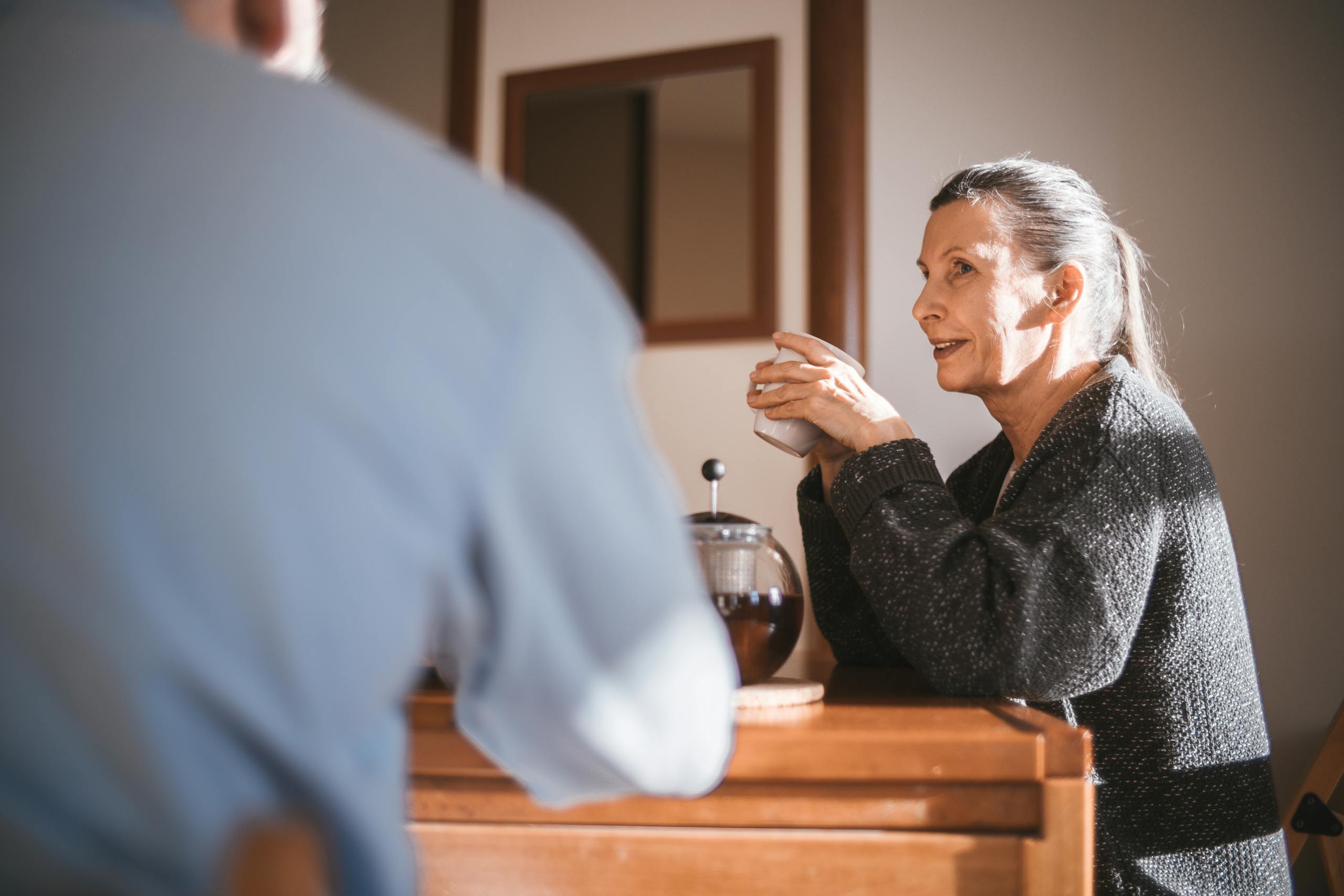 Cheerful senior couple enjoying coffee together in cozy home setting