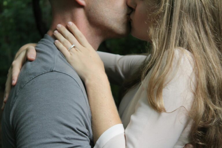 Close-up of a couple kissing outdoors, highlighting romantic love and affection.