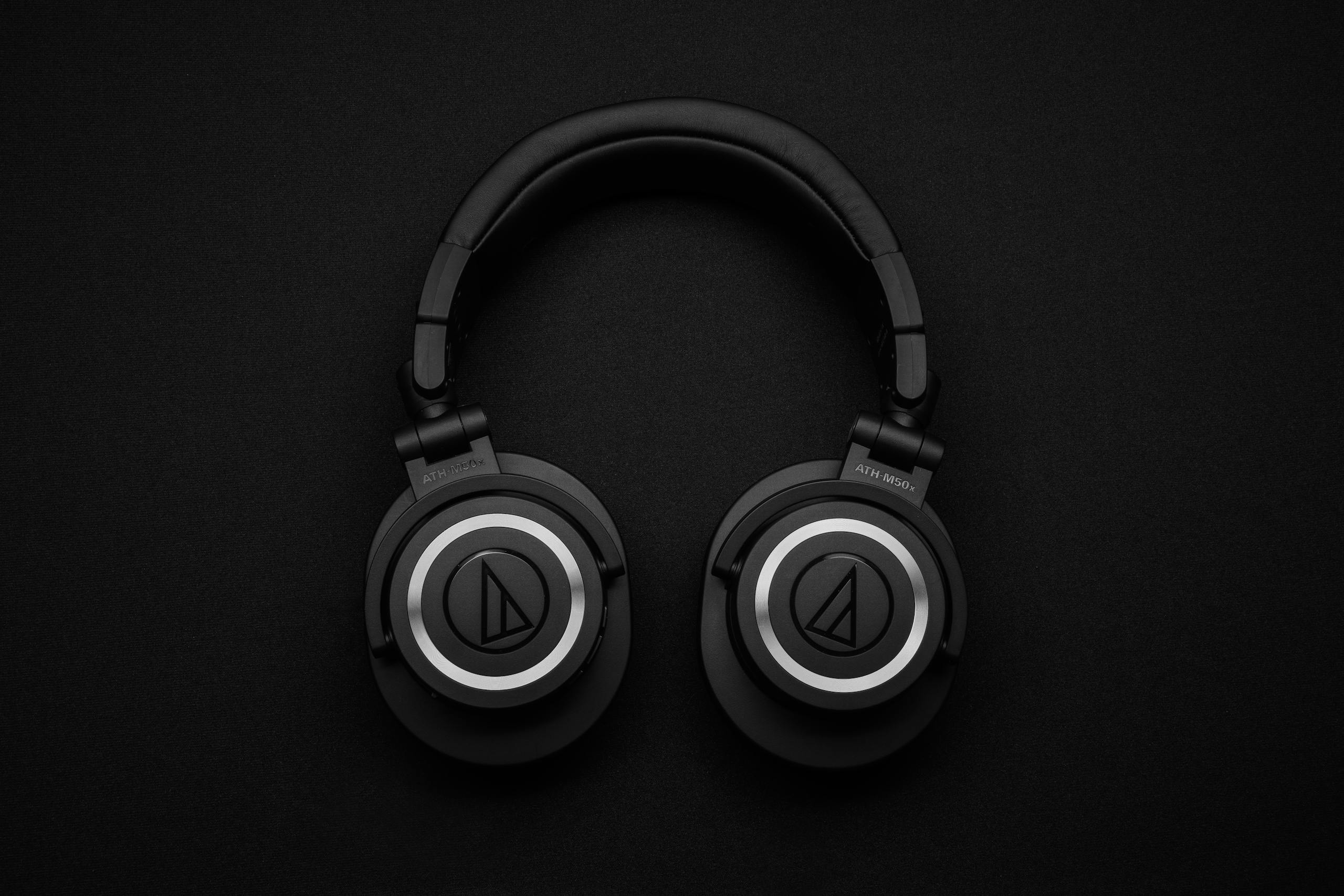 Black over-ear headphones on dark background showcasing modern design.