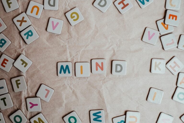 Scattered letter tiles spelling mind on crumpled paper background in close-up