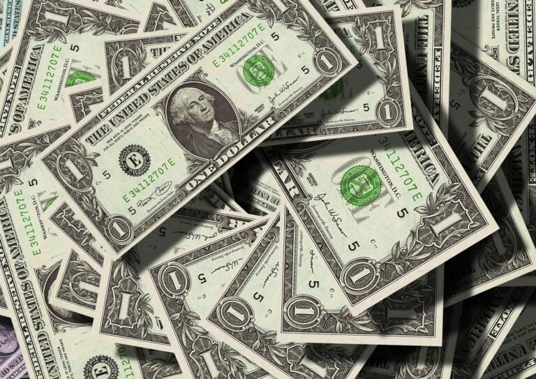 Close-up of scattered US dollar bills symbolizing finance and wealth