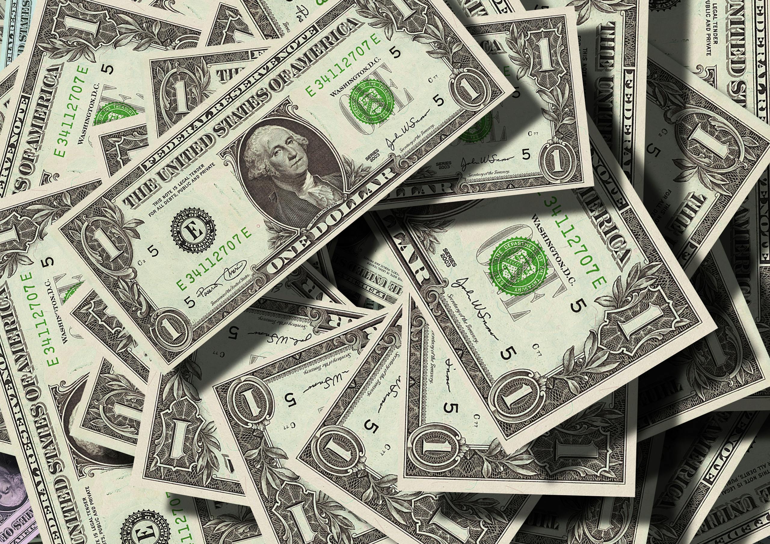 Close-up of scattered US dollar bills symbolizing finance and wealth