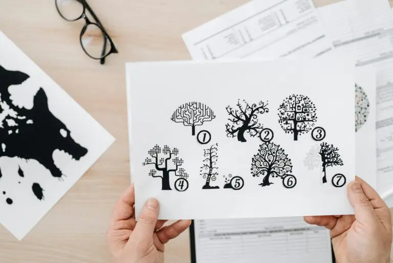 Close-up of hands holding paper with tree test psychological assessment illustration.