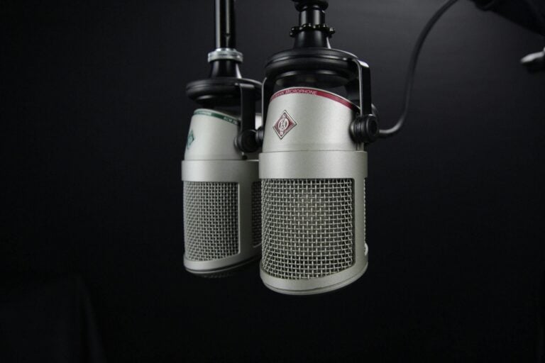 Professional studio microphones on dark background symbolizing focused communication