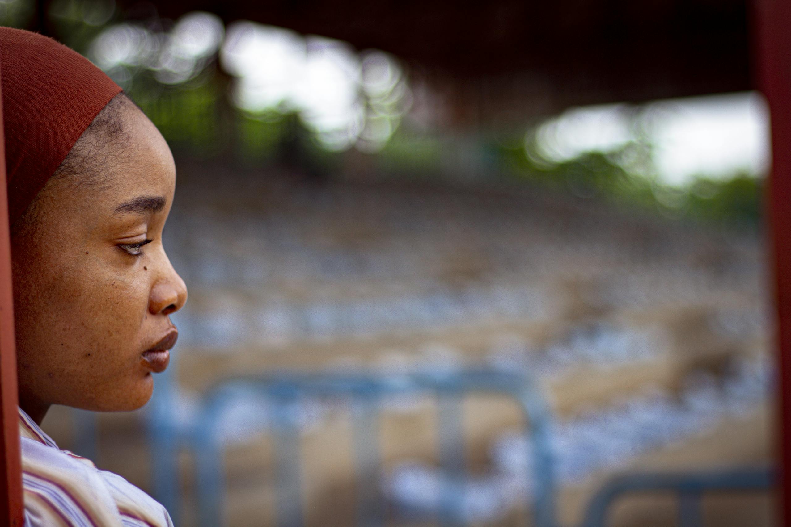 Contemplative portrait of woman with blurred background outdoors in natural light