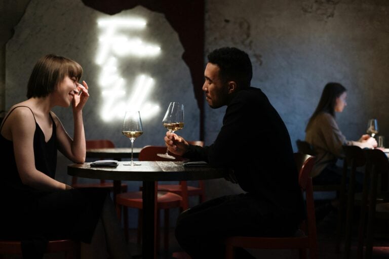 Romantic couple enjoying wine together in stylish bar setting