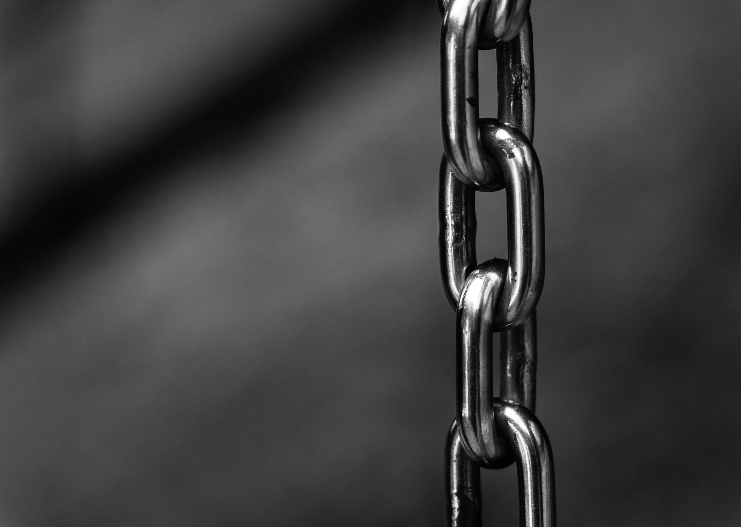 Close-up of strong shiny metallic chain link symbolizing security and strength.