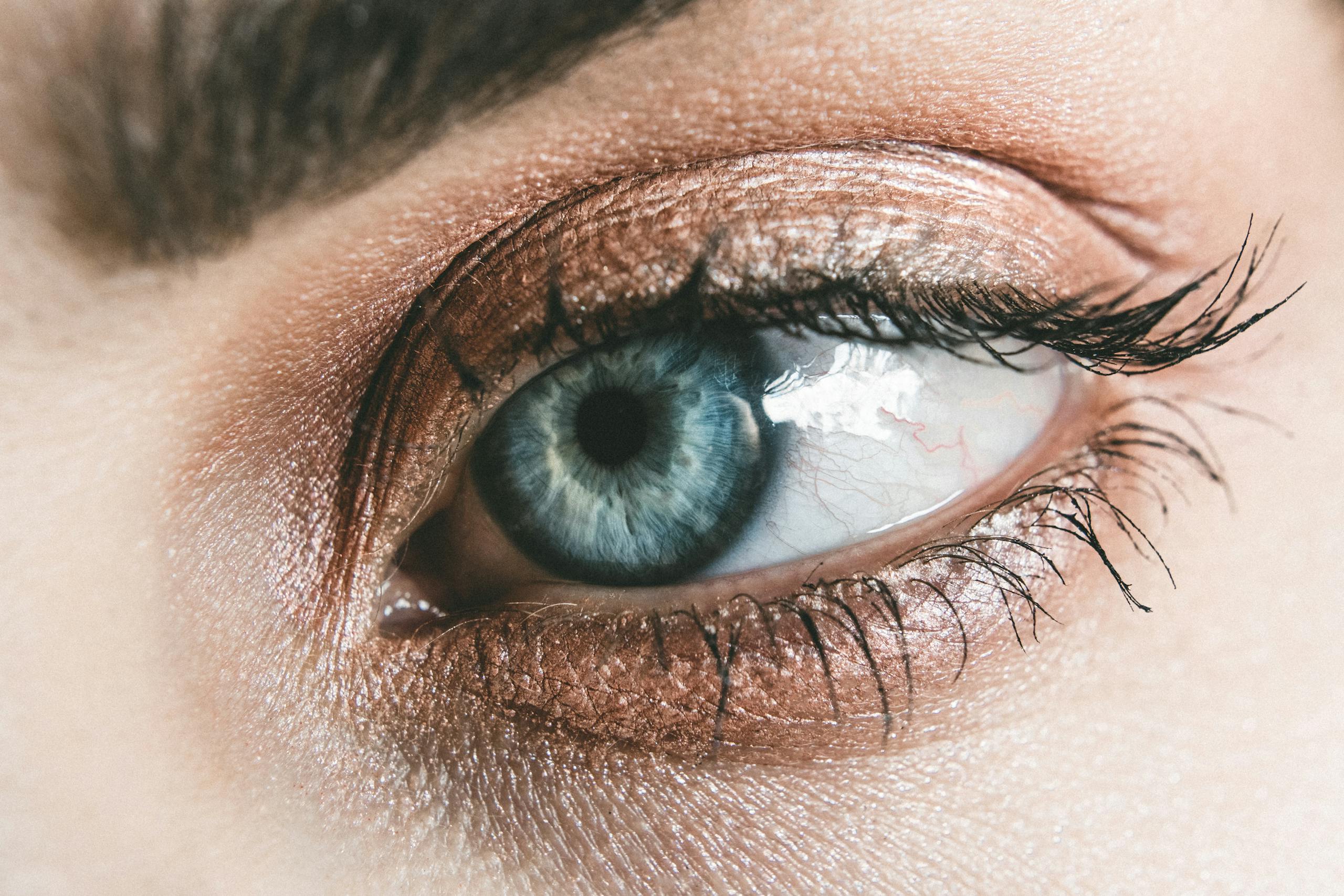 Close up of woman's blue eye with detailed makeup and eyelashes