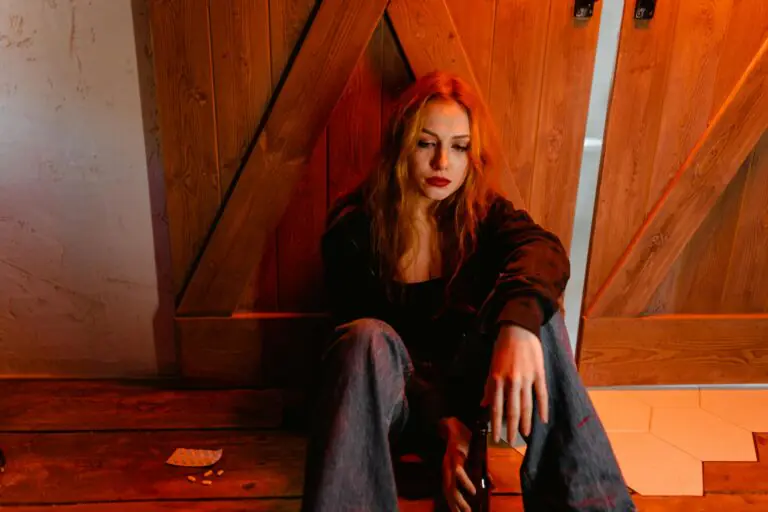 Emotional woman sitting indoors depicting solitude and contemplation