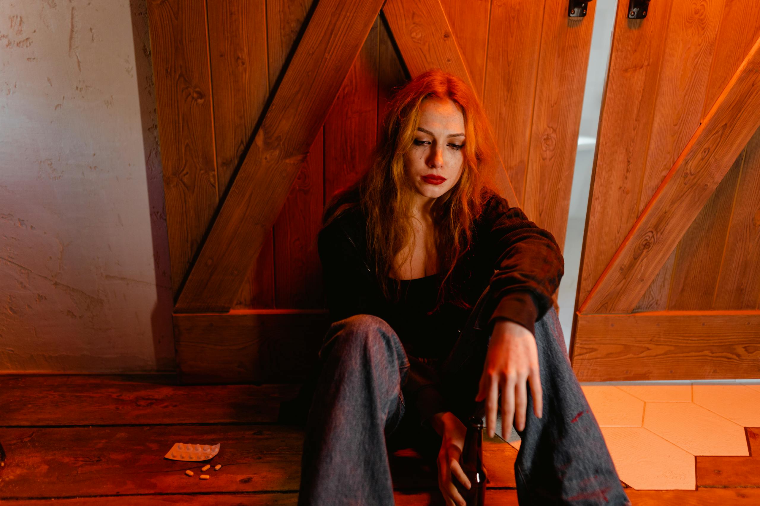 Emotional woman sitting indoors depicting solitude and contemplation
