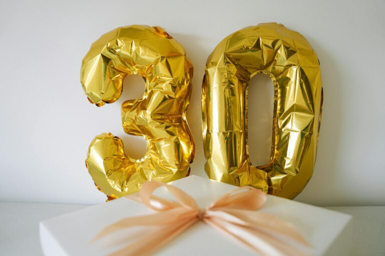 Golden 30 balloon with wrapped gift box for 30th birthday celebration