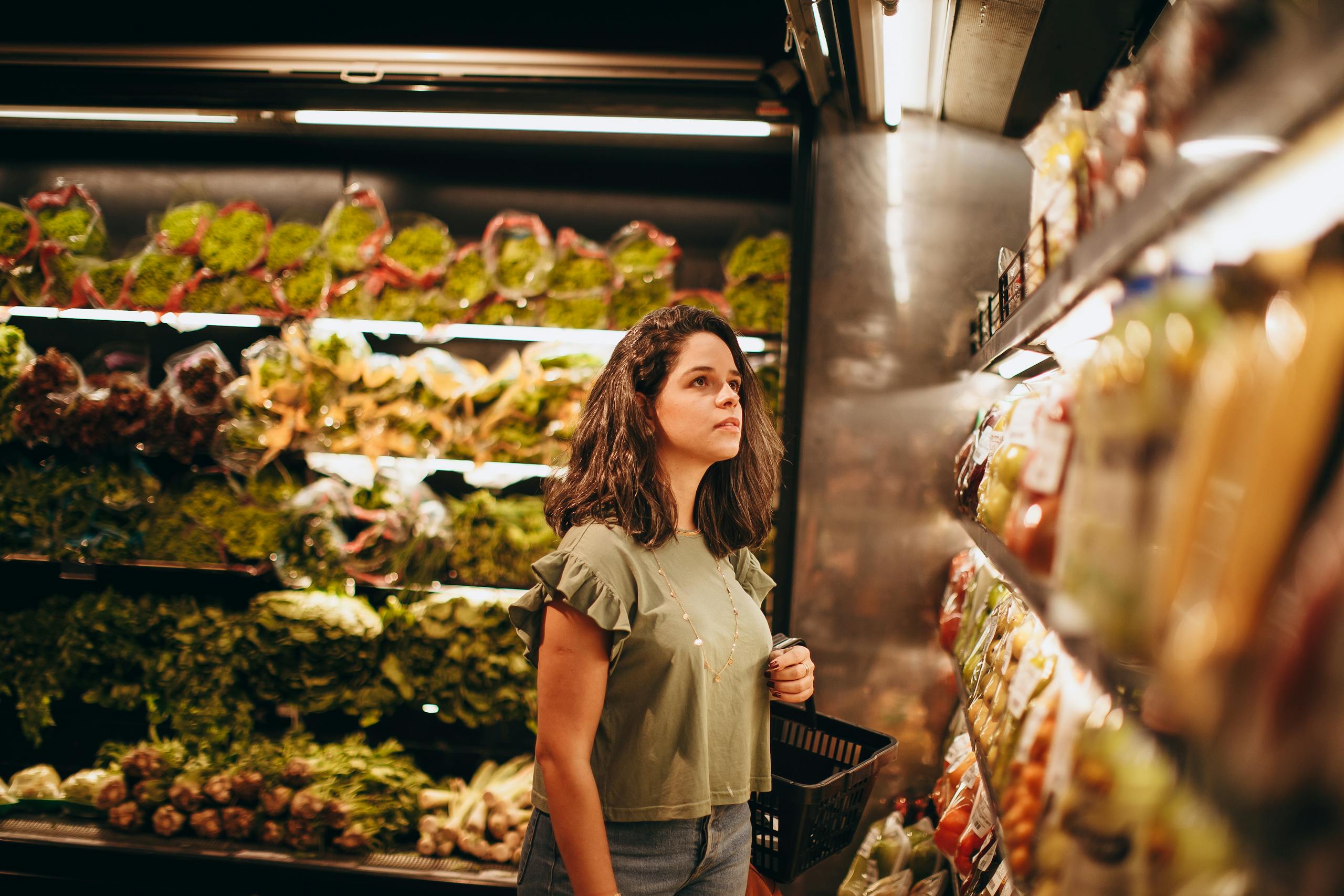 Introvert alone in quiet grocery store aisle early morning with soft lighting